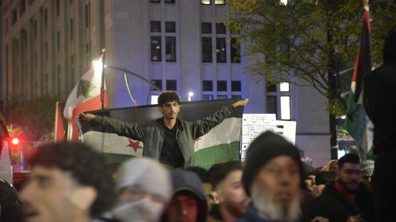 A teen carries a flag