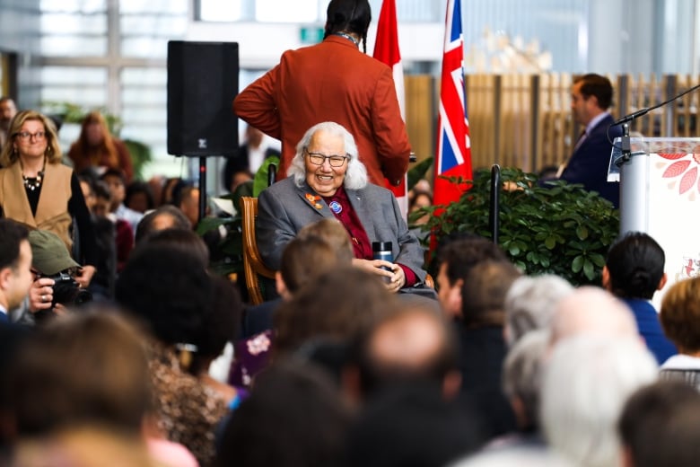 Murray Sinclair, former senator and chair of the Truth and Reconciliation Commission (TRC), smiles while waiting for the swearing-in ceremony for Wab Kinew and his cabinet to begin. 