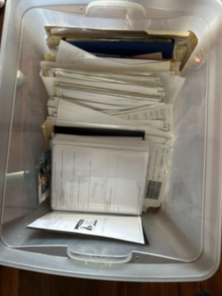 plastic bin full of papers