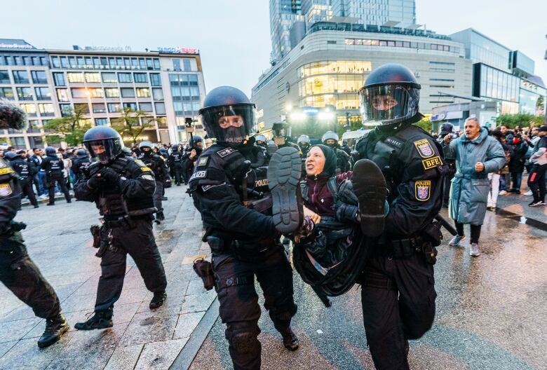 A participant in a pro-Palestinian demonstration is carried away by the police in Frankfurt, Germany on Oct. 18, 2023.