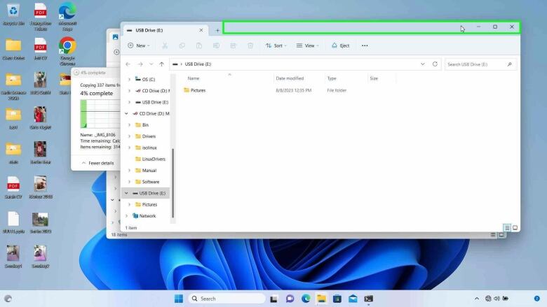 A screengrab of a desktop that shows an entire pictures folder being downloaded onto a USB.