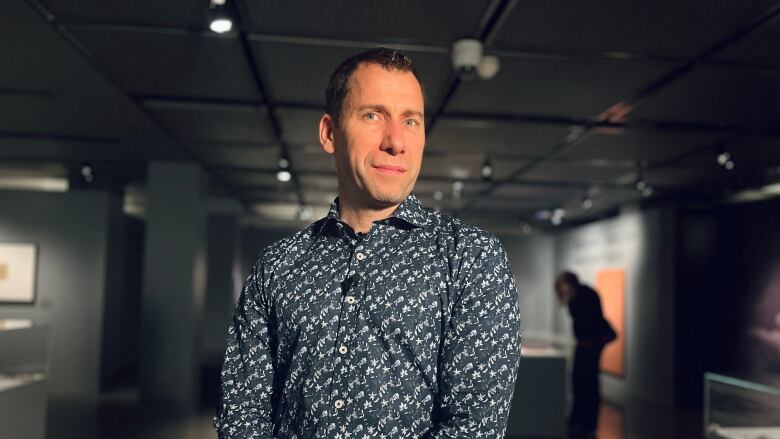 A man stands in an exhibition space