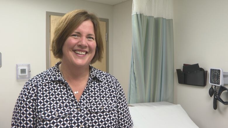 Smiling woman in a medical office. 