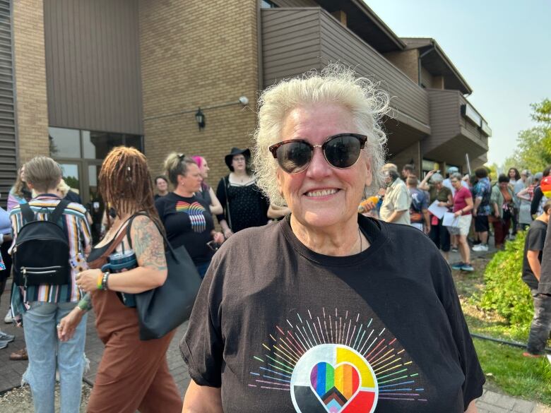 A woman in a black tee.