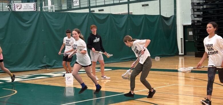 Kids playing lacrosse.