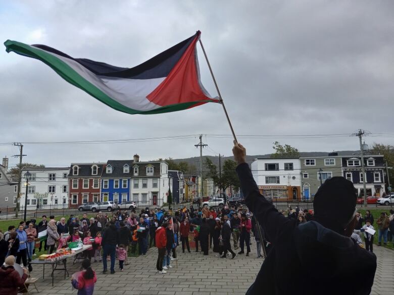 Person on steps saving Palestine flag