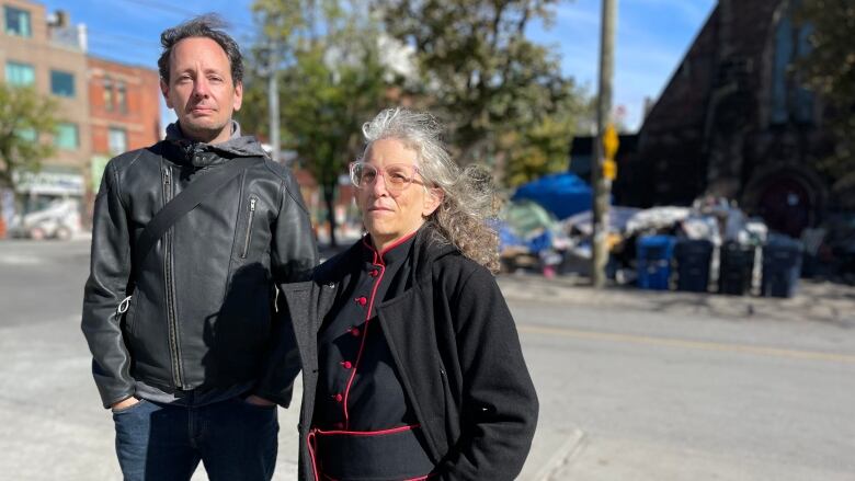 A man and a woman look at the camera for a photo.