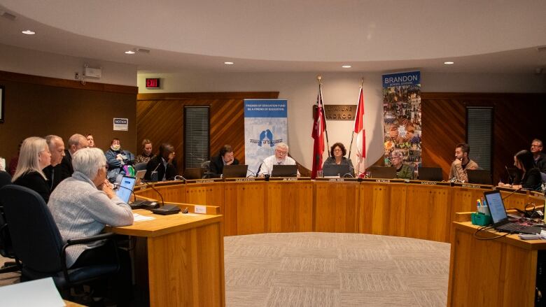 A school board sits at a round table.