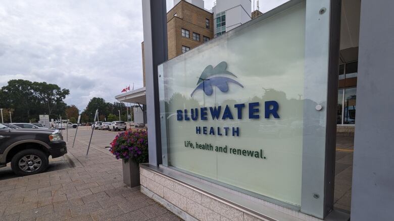 A photo of a window with the Bluewater health logo