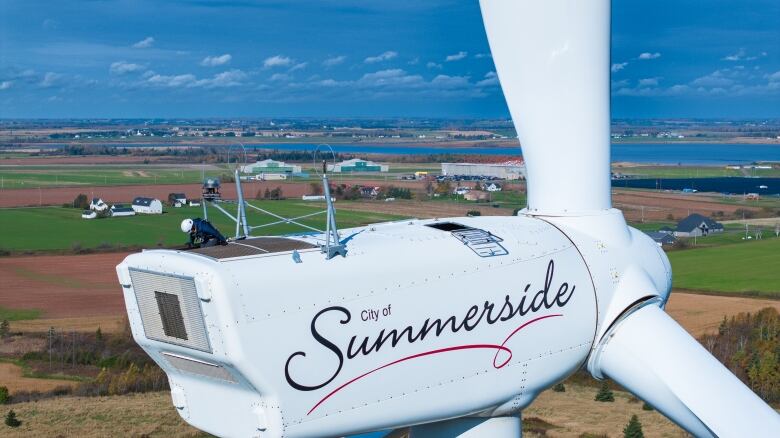 A person atop a wind turbine that's being maintained in Summerside, P.E.I.