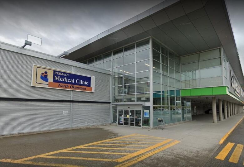 A street view of a Superstore with a sign board advertising a walk-in clinic. 