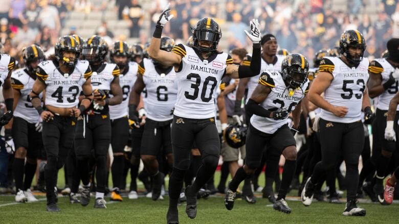 Hamilton Tiger-Cats defensive back Stavros Katsantonis (30) gestures to the crowd before first half exhibition CFL football action against the Montreal Alouettes in Hamilton, Ont. on Saturday, May 28, 2022. 