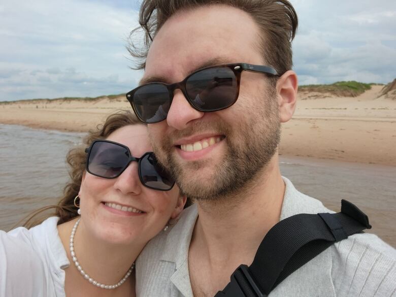 Man and woman in sunglasses smiling 