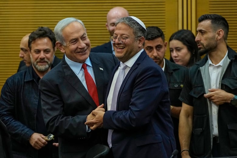 Israeli Prime Minister Benjamin Netanyahu and Israel's National Security Minister Itamar Ben-Gvir smile before Netanyahu's statement in the Knesset, Israel's parliament in Jerusalem, Tuesday, May 23, 2023.