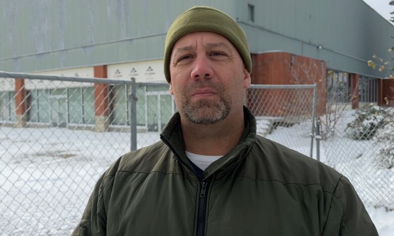 John McDonald is pictured by a wire fence that surrounds the former legion site.