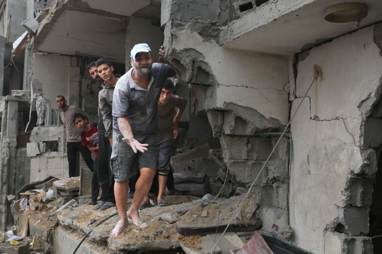 Palestinians stand inside a building destroyed in the Israeli bombardment of Gaza in Rafah on Sunday. 