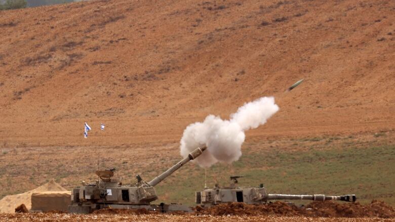 A tank fires artillery.