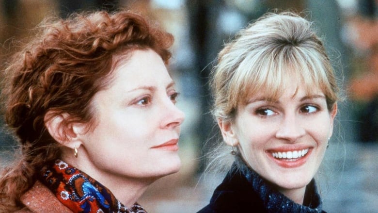 Closeup of Susan Sarandon (left) looking into the distance and Julia Roberts (right) smiling and looking at Sarandon in the film Stepmom. 