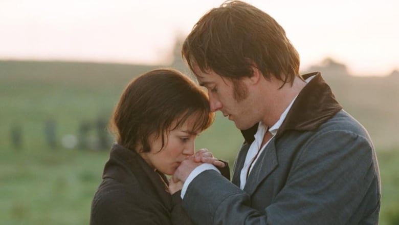 Keira Knightley (left) and Matthew Macfadyen (right) in Pride & Prejudice. They're standing face to face and she's kissing his hands. A field is in the background. 