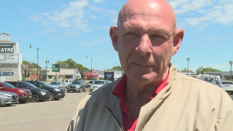 Man standing in parking lot.