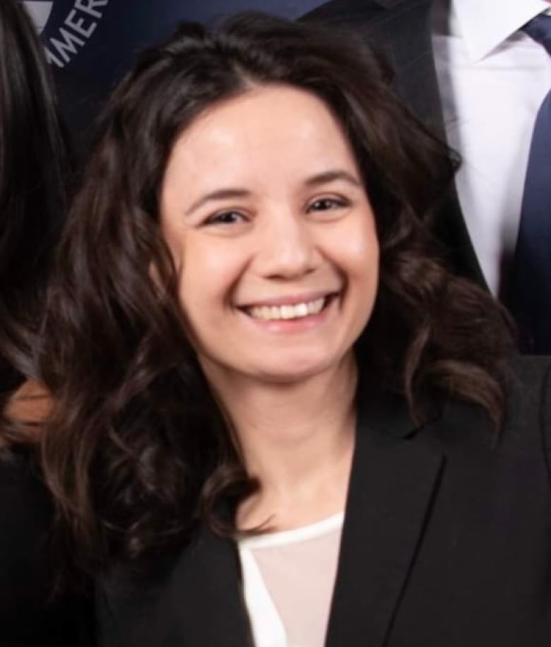 A smiling woman with dark hair.