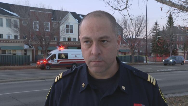 A close-up shot of a man in a dark blue uniform.