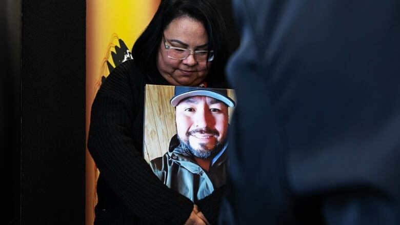 A woman holding a photo. 