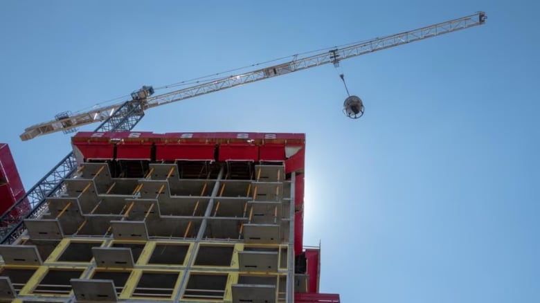 Tower crane over unfinished building