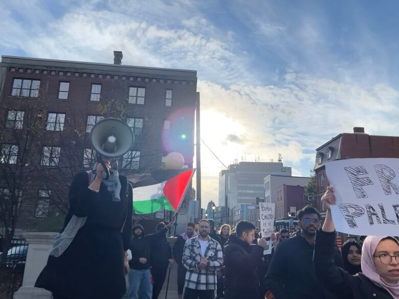 A protester yells into a megaphone.