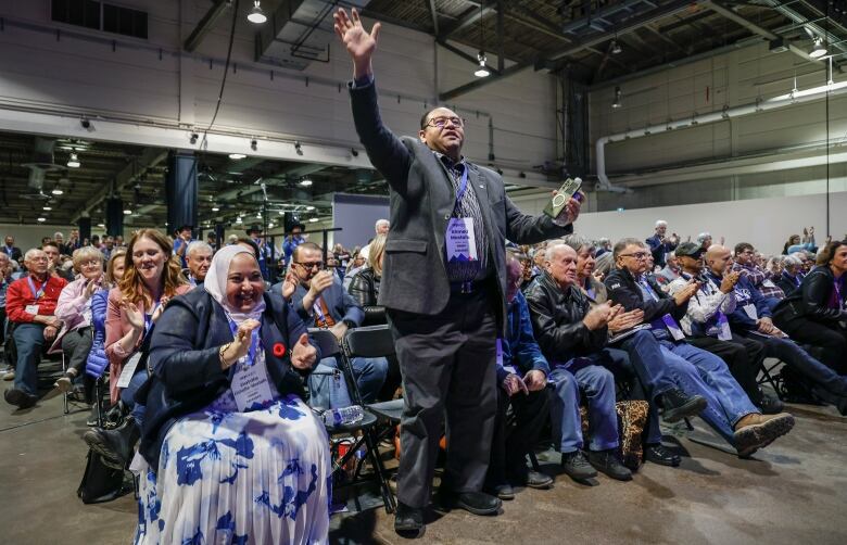 People in a crowd cheer.