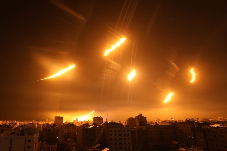 The sky over Gaza is lit up by flares dropped by the Israeli military.