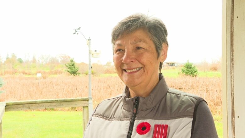 Woman wearing poppy.