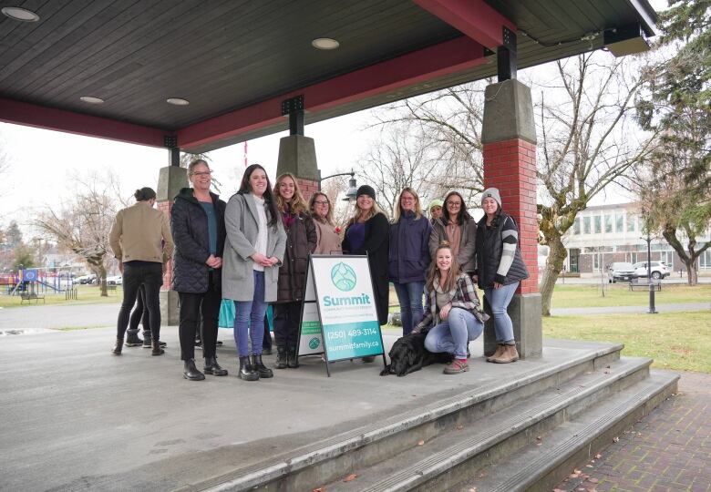 Pictured are staff and volunteers from Summit Community Services Society in Cranbrook on Tuesday, Nov. 7, 2023. They are joined by West the labrador retriever, who was celebrated for his service in the community. 