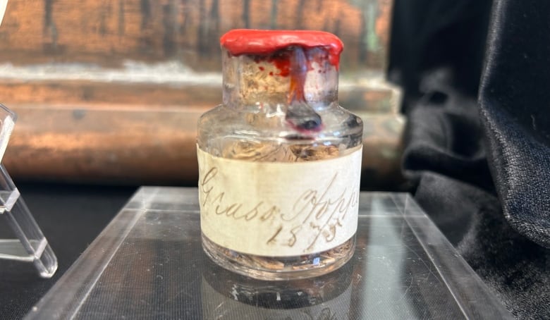 A glass jar is sealed with red wax. A label has 