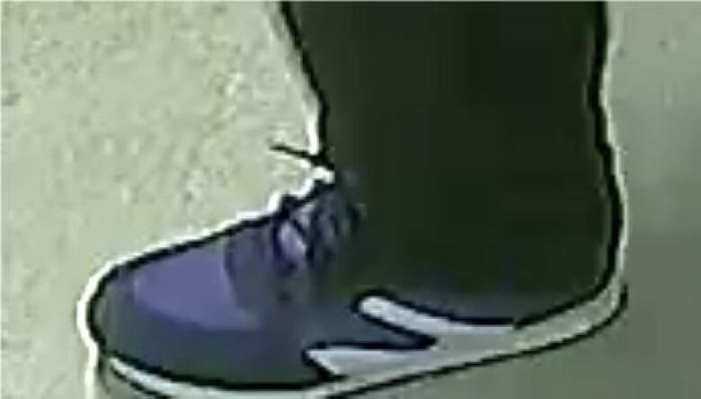 A close-up picture of blue shoes, with a white design that appears like a whale's mouth.