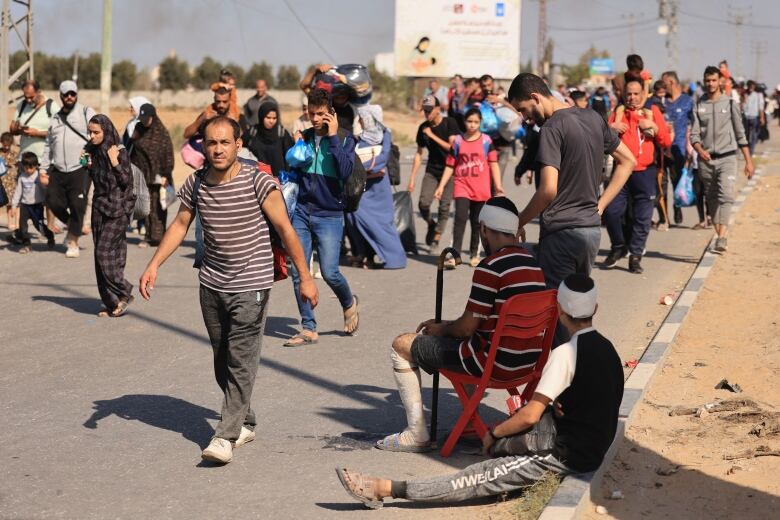 Palestinian families are seen walking along a road on Friday, as they flee fighting in the north of the Gaza Strip.