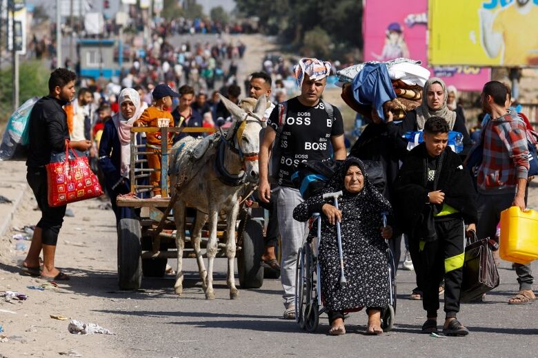 Civilians are seen moving toward the southern part of the Gaza Strip on Friday.