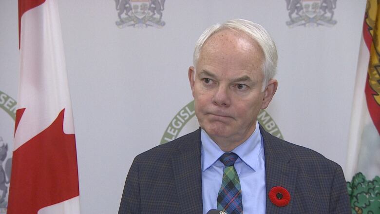 A politician stands in front of a microphone. 