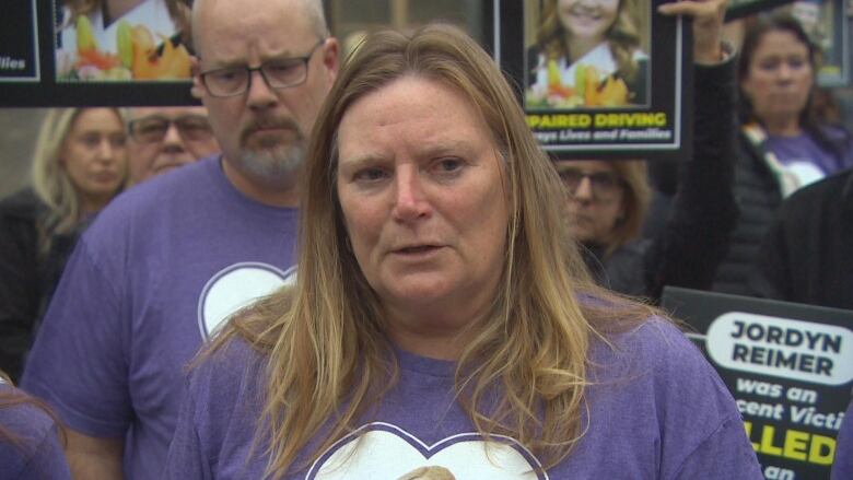 A woman in a purple shirt. 