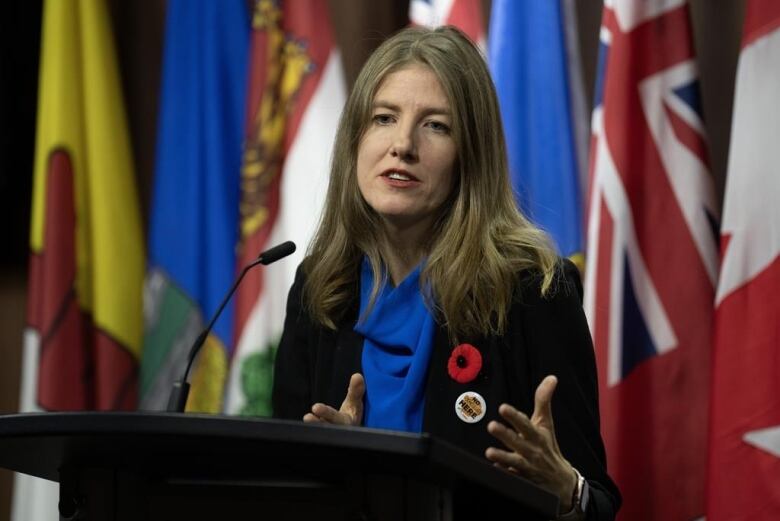 A woman speaks at a podium.