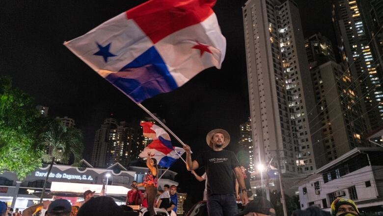 Demonstrators wave Panamanian flags during a protest against First Quantum Minerals Ltd. in Panama City, Panama.