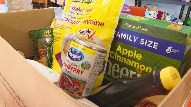 Cereal and other food in a cardboard box.