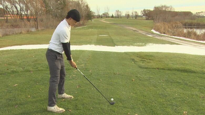 A man is pictured playing golf.