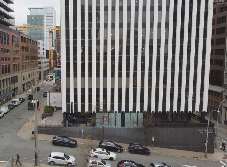 Street scene with a sign saying Centennial Building on the right side.