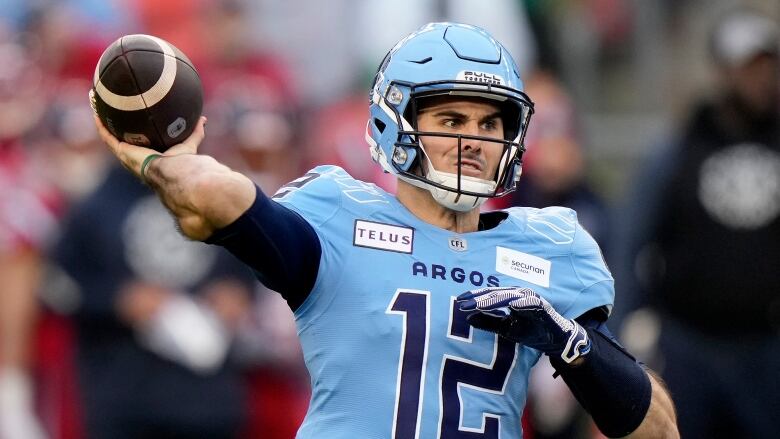 A men's football player winds up a throw.