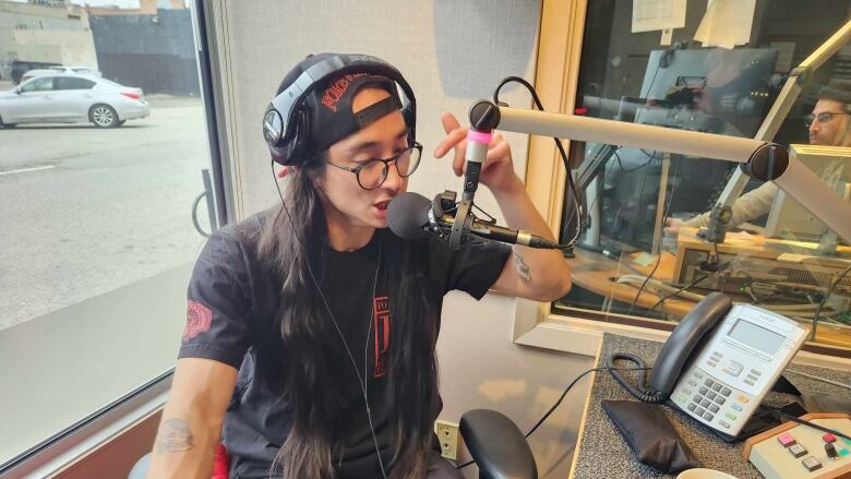 Poppa Nuge / Nuge Bird is in CBC Kelowna studio. He is beatboxing into a microphone. 