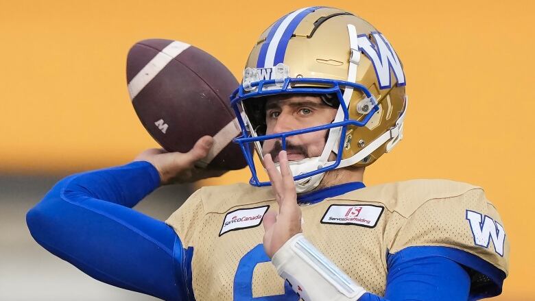 A football player throws a football.