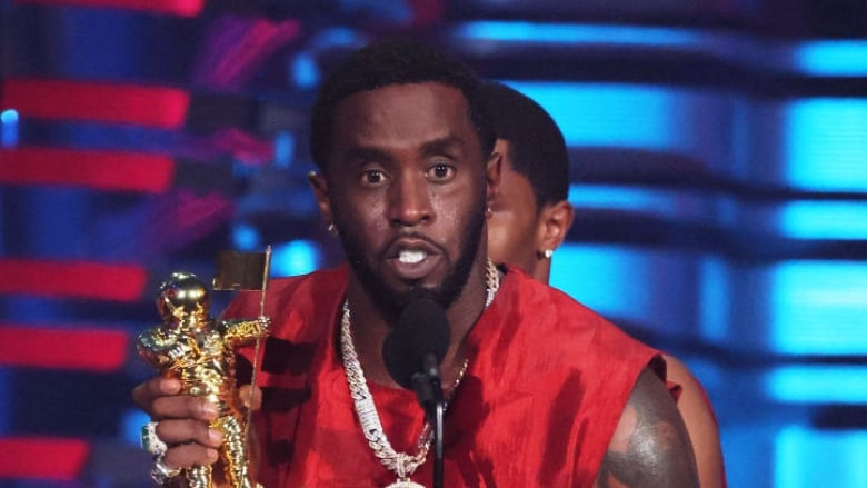 Sean 'Diddy' Combs accepts an award on stage.