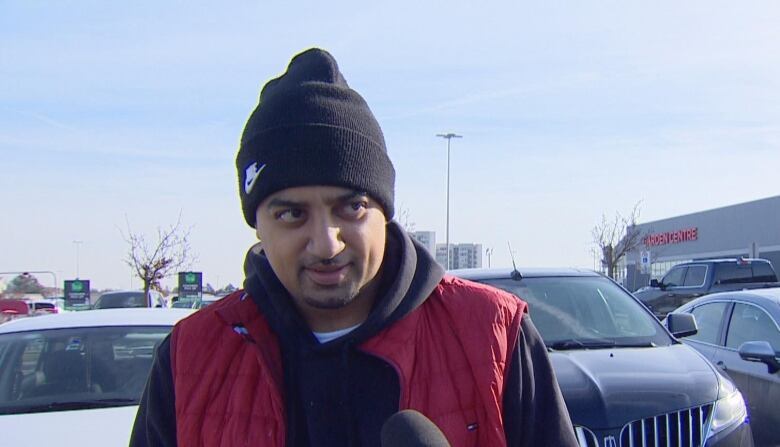 Junaid Chaudhry standing outside a Canadian Tire in MIssissauga.