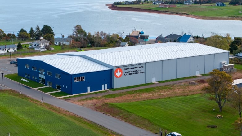 A photo taken from a drone shows a new rink, blue metal in the front, grey metal in the back. In the background is the nearby harbour.